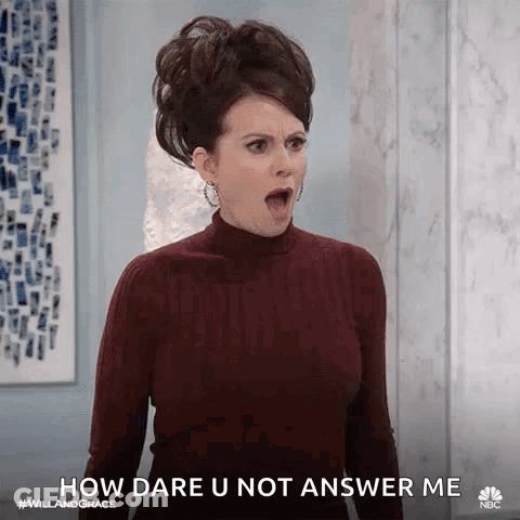 A Woman In A Turtleneck Sweater Is Making A Funny Face And Says `` How Dare U Not Answer Me '' . GIF
