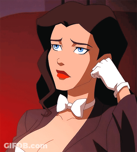 A Woman In A Tuxedo And Bow Tie Is Holding Her Hand To Her Face GIF