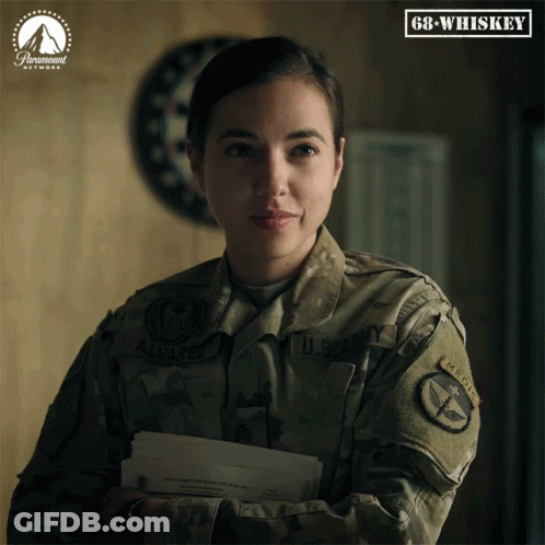 A Woman In A U.s. Army Uniform Is Holding A Letter GIF