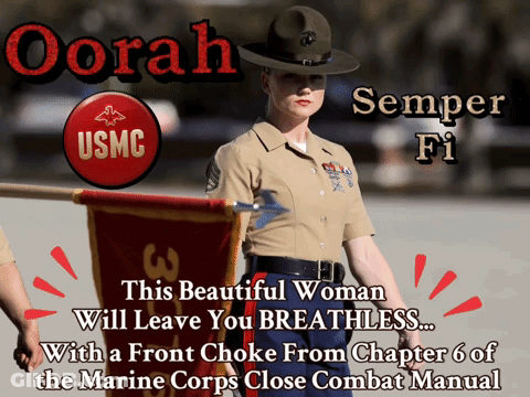 A Woman In A Usmc Uniform Stands In Front Of A Banner GIF