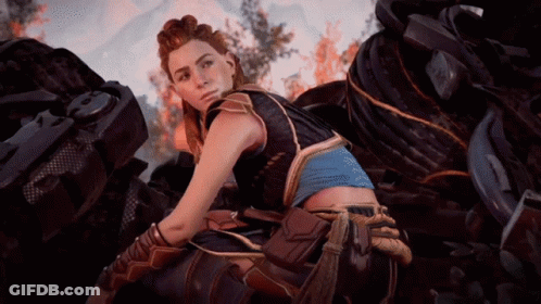 A Woman In A Video Game Is Sitting In Front Of A Pile Of Tires GIF