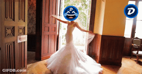 A Woman In A Wedding Dress Has A Smiley Face On Her Head With The Letter D On It GIF