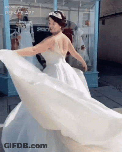 A Woman In A Wedding Dress Is Dancing In Front Of A Store With The Number 280 On It GIF