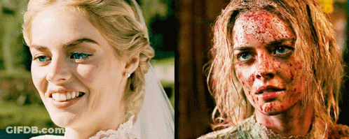 A Woman In A Wedding Dress Is Smiling Next To Another Woman With Blood On Her Face GIF
