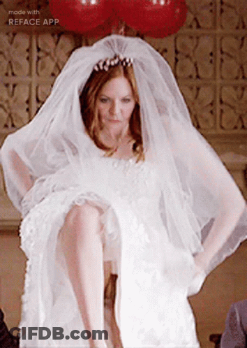 A Woman In A Wedding Dress With A Veil On Her Head Is Made With The Reface App GIF