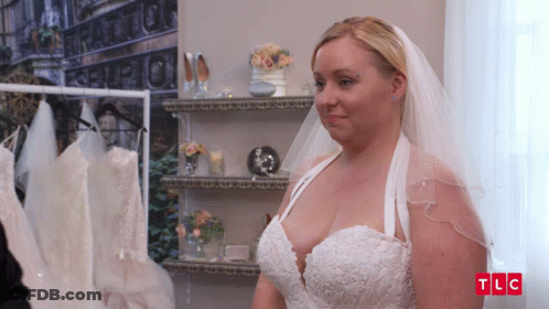 A Woman In A Wedding Dress With The Letters Tlc On The Bottom Left GIF