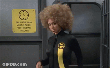 A Woman In A Wetsuit Is Standing In Front Of A Sign That Says Each Henchman Must Clock In With His Own Time Card GIF