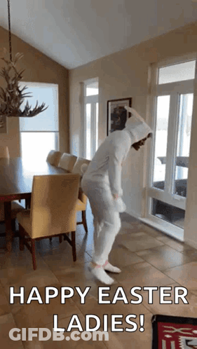 A Woman In A White Bunny Costume Is Dancing In A Living Room With The Words Happy Easter Ladies Below Her GIF
