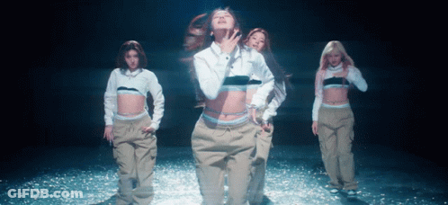 A Woman In A White Calvin Klein Shirt Is Dancing With Other Women GIF