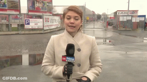 A Woman In A White Coat Is Holding A Microphone That Says Cnn Prima News GIF