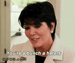 A Woman In A White Coat Is Saying `` You 'Re A Bunch A Haters '' . GIF