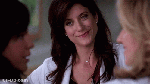 Woman Smiling And Talking In White Coat GIF