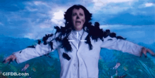 A Woman In A White Coat With A Cross On Her Chest GIF