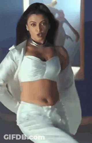 A Woman In A White Crop Top And White Pants GIF