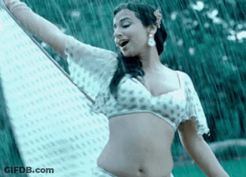 A Woman In A White Crop Top Is Dancing In The Rain . GIF