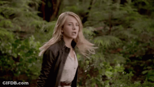 Woman In White Dress And Black Jacket In Woods GIF