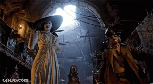 A Woman In A White Dress And A Man In A Trench Coat Are Standing In A Dark Room . GIF