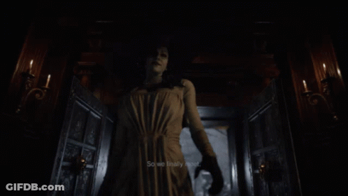 A Woman In A White Dress And Hat Is Holding A Sword GIF