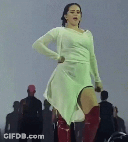 A Woman In A White Dress And Red Boots Is Dancing On Stage . GIF
