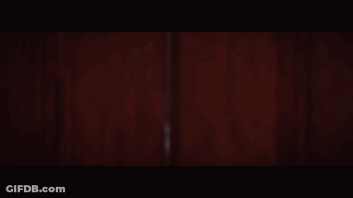 A Woman In A White Dress And Veil Is Smiling GIF