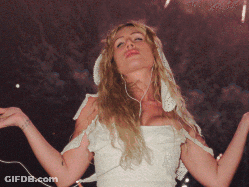 A Woman In A White Dress Has A Tattoo On Her Wrist That Says ' I Love You ' On It GIF