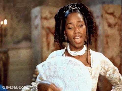 A Woman In A White Dress Holding A Fan GIF