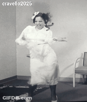 A Woman In A White Dress Is Dancing In A Black And White Photo Taken By Cravello 2025 GIF