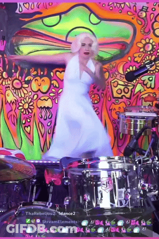 A Woman In A White Dress Is Dancing In Front Of A Drum Set That Says Sis On It GIF