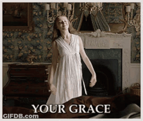 A Woman In A White Dress Is Dancing In Front Of A Fireplace With The Words " Your Grace " Written Below Her GIF