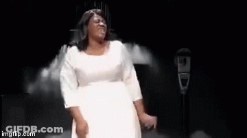 A Woman In A White Dress Is Dancing On A Stage With The Words `` I Made It '' Written Below Her . GIF