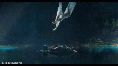A Woman In A White Dress Is Flying Through The Air GIF