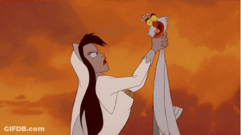 A Woman In A White Dress Is Holding A Bird In Her Hand GIF