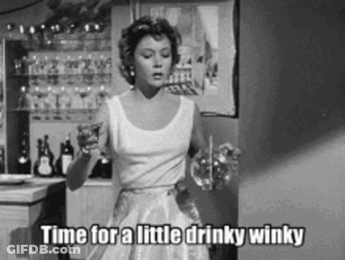 Woman In White Dress Holding Wine Glass Saying Little Drinky Winky GIF
