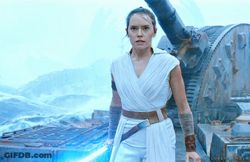 A Woman In A White Dress Is Holding A Light Saber In Her Hand GIF