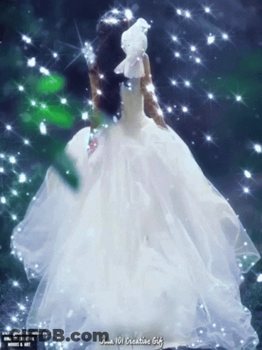 A Woman In A White Dress Is Holding A White Bird On Her Head GIF