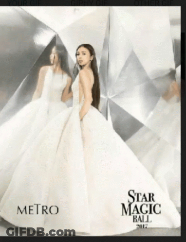 A Woman In A White Dress Is On The Cover Of The Star Magic Ball Magazine GIF