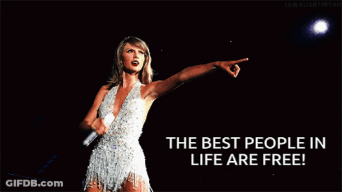 A Woman In A White Dress Is Pointing With The Words " The Best People In Life Are Free " Below Her GIF
