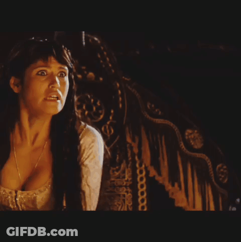 A Woman In A White Dress Is Reaching Out Towards A Man In A Black Shirt GIF