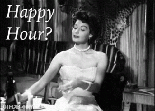 A Woman In A White Dress Is Sitting At A Table With The Words Happy Hour Above Her GIF