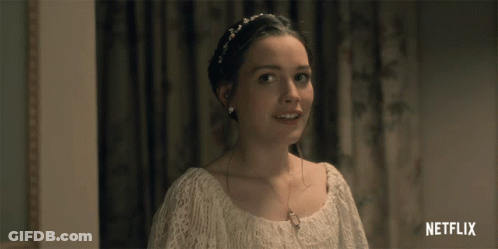 A Woman In A White Dress Is Smiling With A Netflix Logo In The Corner GIF