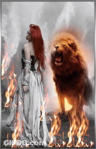 A Woman In A White Dress Is Standing In Front Of A Lion In A Field Of Fire GIF