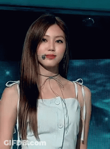 Woman In White Dress Standing In Front Of Microphone GIF