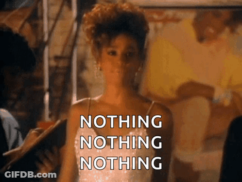 A Woman In A White Dress Is Standing In Front Of A Sign That Says " Nothing Nothing Nothing " GIF