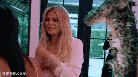 A Woman In A White Dress Is Standing Next To A Woman In A Black Dress . GIF