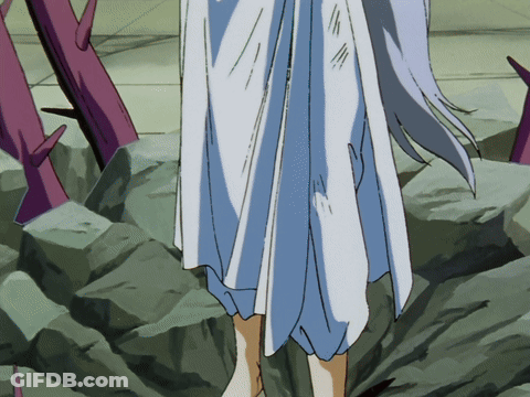 A Woman In A White Dress Is Standing On A Rocky Surface GIF