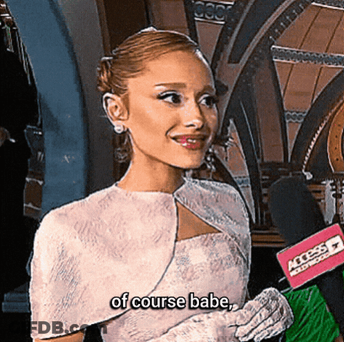 A Woman In A White Dress Is Talking Into A Microphone And The Words Of Course Babe Are Next To Her GIF
