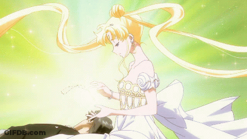 A Woman In A White Dress Is Touching A Man 'S Face GIF