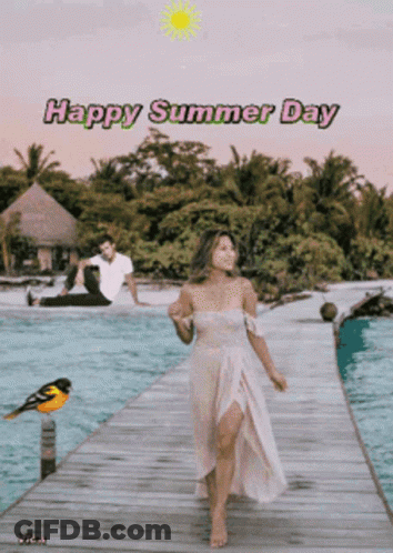 A Woman In A White Dress Is Walking On A Dock With A Man Sitting On The Beach Behind Her And The Words Happy Summer Day GIF