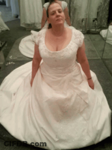 A Woman In A White Dress Sits On The Floor GIF