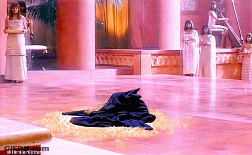 A Woman In A White Dress Stands Next To A Woman In A White Dress In A Pink Room GIF